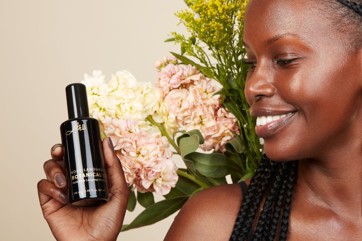 Woman holding a bottle of Body Language Botanical Oil